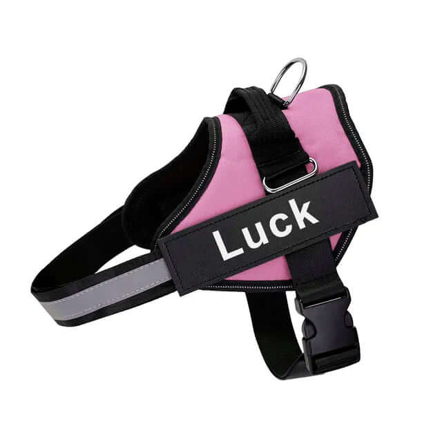 Pink no-pull dog harness with adjustable straps, reflective stitching, quick-release buckle, and "Luck" label for safe, comfortable walks